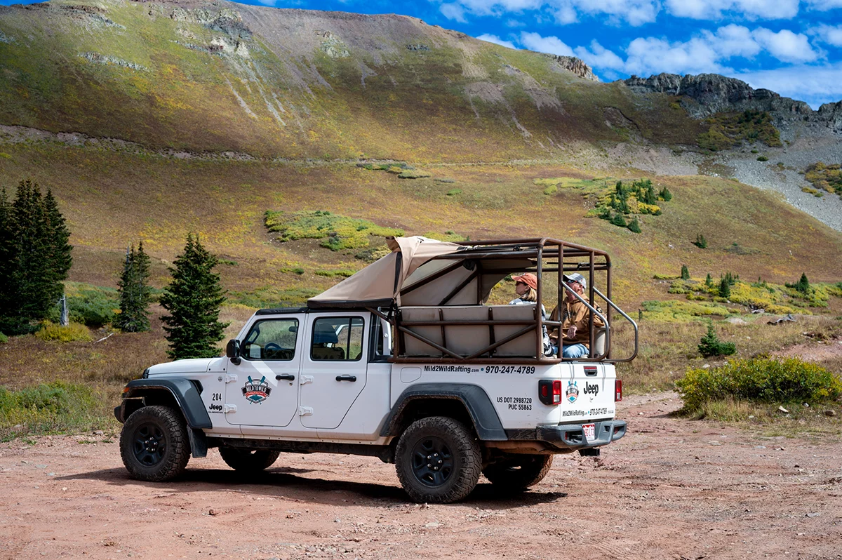 A tour Jeep parked in the mountains