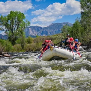A river rafting group paddling through rapids